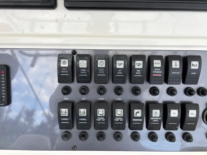 Slide: The Image of Control panel of a 2015 Robalo R300 Center Console boat with labeled switches. - 18