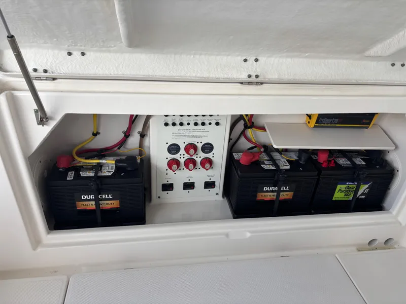 Slide: The Image of 2015 Robalo R300 Center Console battery compartment with Duracell batteries and control panel. - 19
