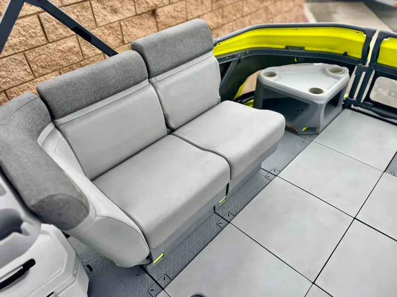 Slide: The Image of 2023 Sea-Doo Switch Cruise 18 interior with gray seating and cup holders. - 11