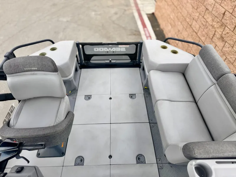 Slide: The Image of 2023 Sea-Doo Switch Cruise 18 interior with gray seating and spacious layout. - 18