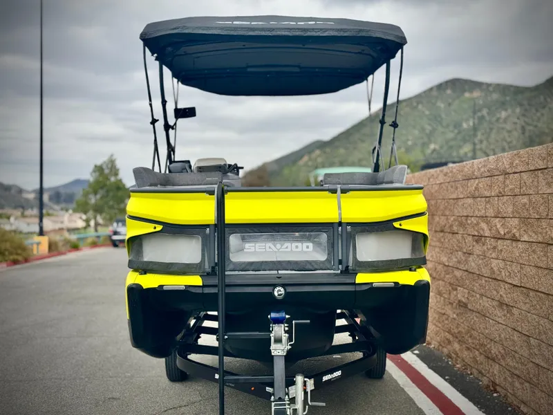 Slide: The Image of 2023 Sea-Doo Switch Cruise 18 on trailer, parked with mountains in background. - 2