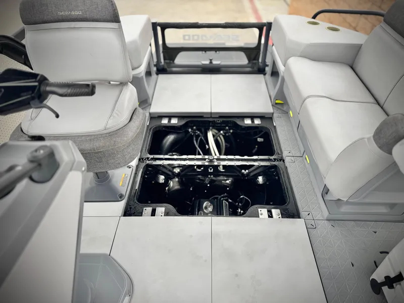Slide: The Image of 2023 Sea-Doo Switch Cruise 18 interior with open engine compartment, showcasing seating and controls. - 27