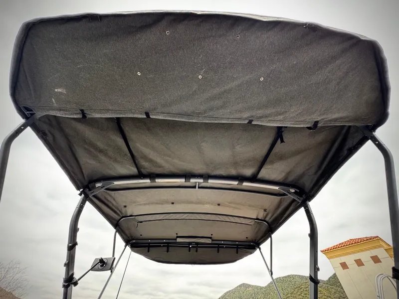 Slide: The Image of 2023 Sea-Doo Switch Cruise 18 canopy viewed from below, showcasing sturdy frame and fabric. - 29