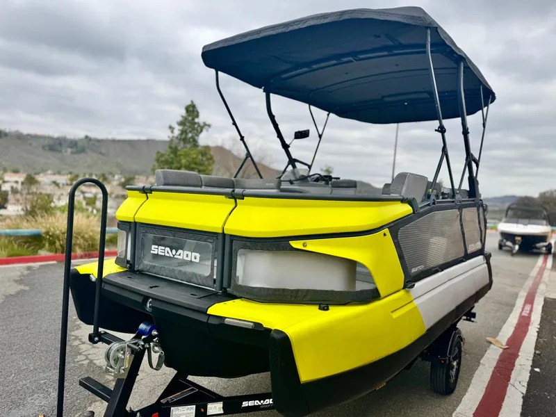 Slide: The Image of 2023 Sea-Doo Switch Cruise 18 with canopy, parked on a trailer, featuring vibrant yellow accents. - 3