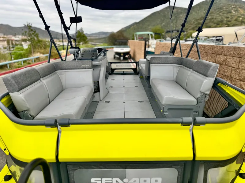 Slide: The Image of 2023 Sea-Doo Switch Cruise 18 pontoon boat with spacious seating and modern design. - 8