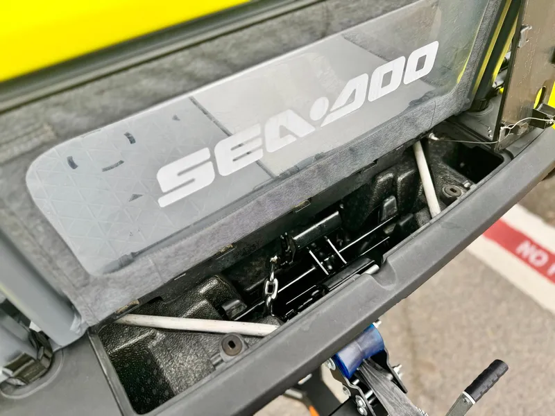 Slide: The Image of 2023 Sea-Doo Switch Cruise 18 storage compartment with visible branding and mechanical components. - 9