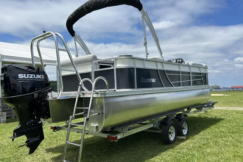 Slide: The Image of 2023 Landau Island Breeze 232 Cruise pontoon boat with Suzuki motor on trailer. - 0