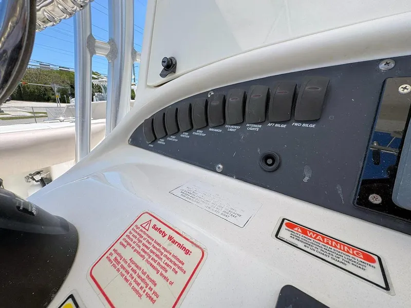 Slide: The Image of Control panel of a 2004 Boston Whaler 320 Outrage boat with warning labels. - 11