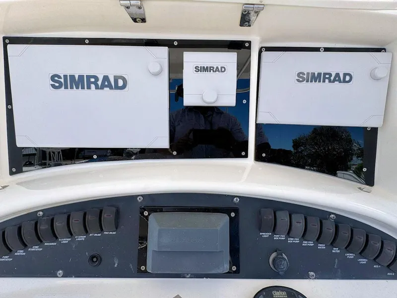 Slide: The Image of Control panel of a 2004 Boston Whaler 320 Outrage with Simrad navigation equipment. - 12
