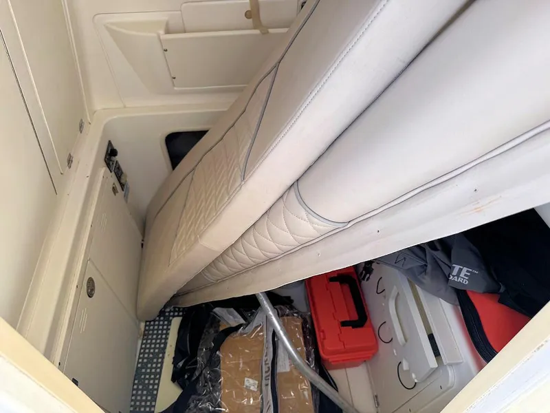 Slide: The Image of Interior cabin of 2004 Boston Whaler 320 Outrage with storage and seating. - 13