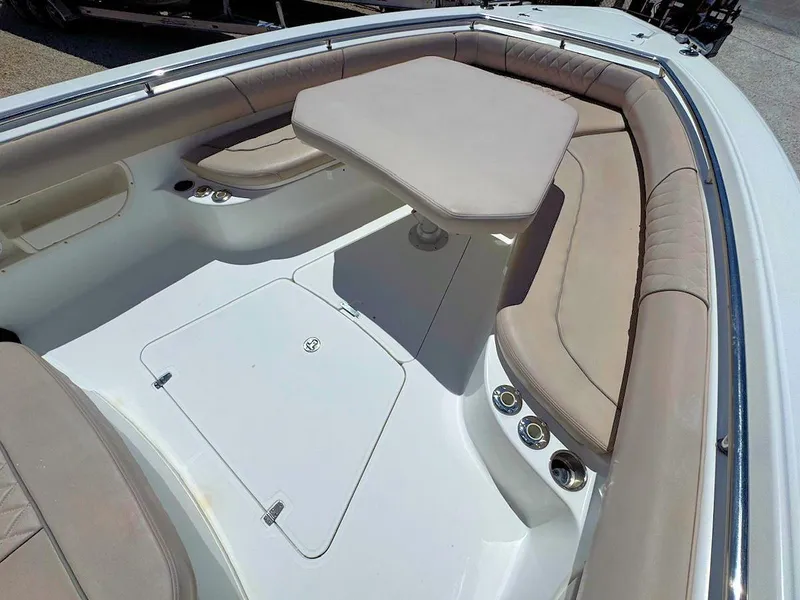 Slide: The Image of 2004 Boston Whaler 320 Outrage boat interior with cushioned seating and table. - 15