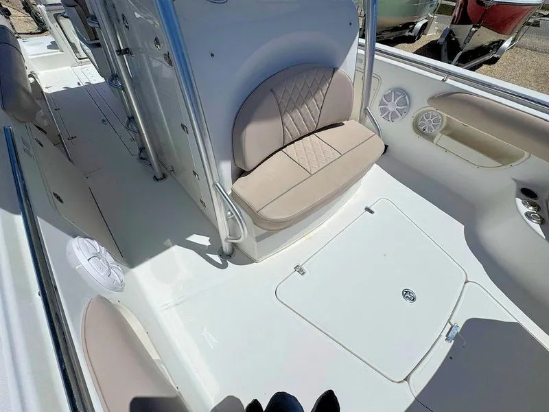 Slide: The Image of 2004 Boston Whaler 320 Outrage boat interior with seating and storage compartments. - 16