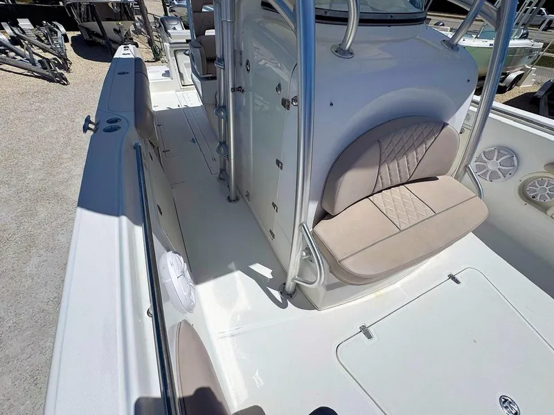 Slide: The Image of 2004 Boston Whaler 320 Outrage boat interior with cushioned seating and sleek design. - 17