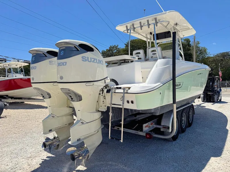 Slide: The Image of 2004 Boston Whaler 320 Outrage with twin Suzuki 300 engines on a trailer. - 2