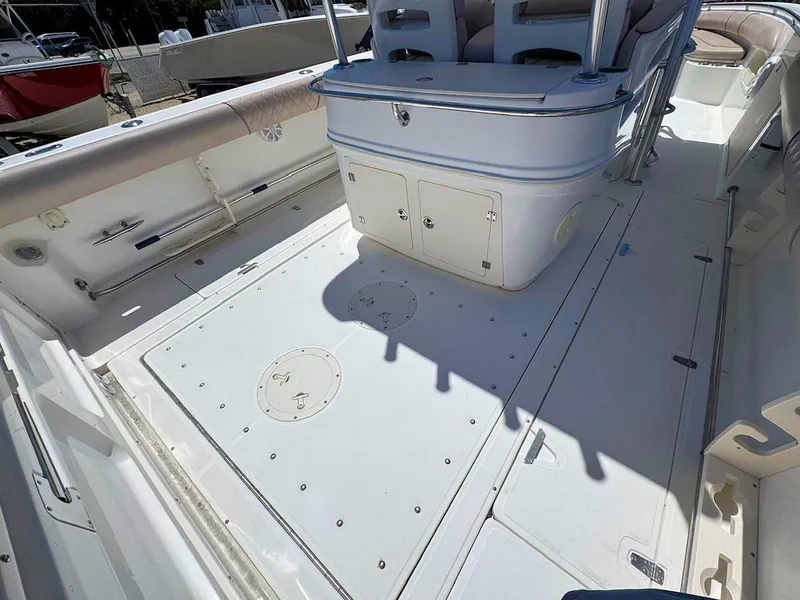 Slide: The Image of 2004 Boston Whaler 320 Outrage boat deck, featuring spacious seating and storage compartments. - 8