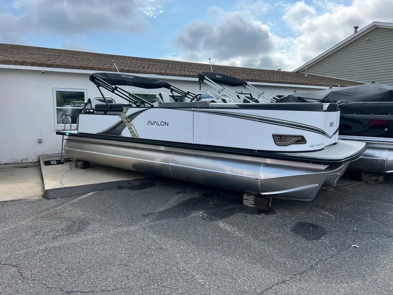 Slide: The Image of 2025 Avalon 2385 LSZ pontoon boat parked outdoors, showcasing sleek design and modern features. - 1