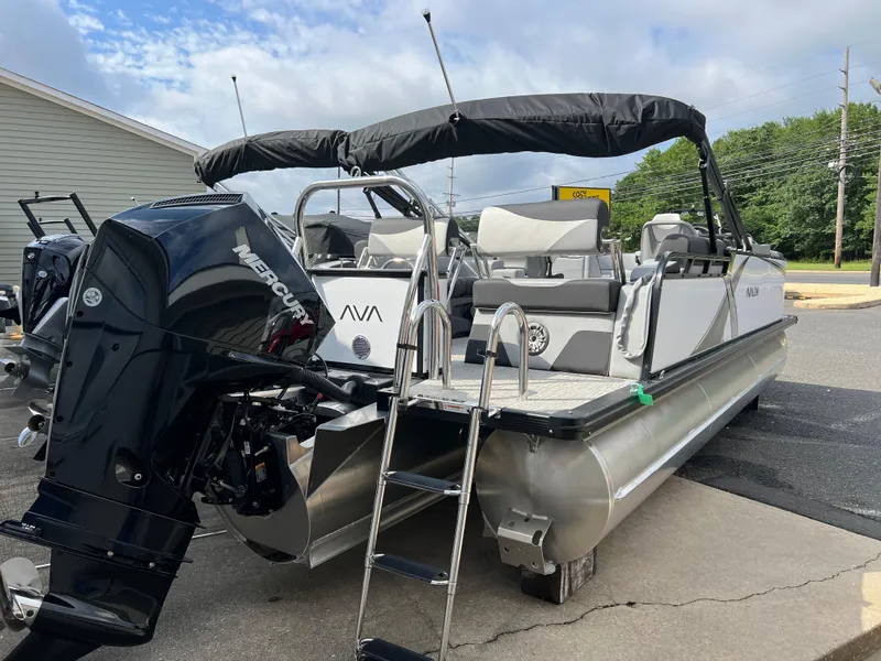 Slide: The Image of 2025 Avalon 2385 LSZ pontoon boat with Mercury outboard motor, docked outdoors. - 3