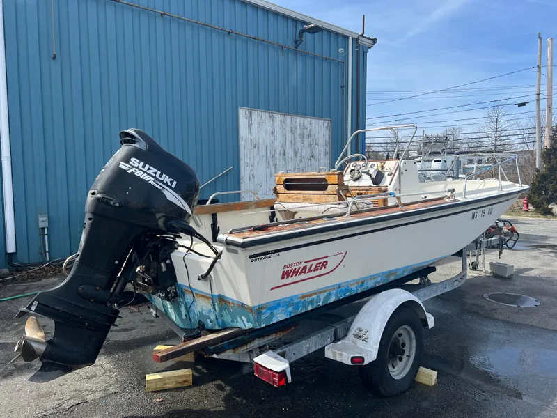 Slide: The Image of 1992 Boston Whaler 19 Outrage boat on trailer with Suzuki outboard motor. - 3