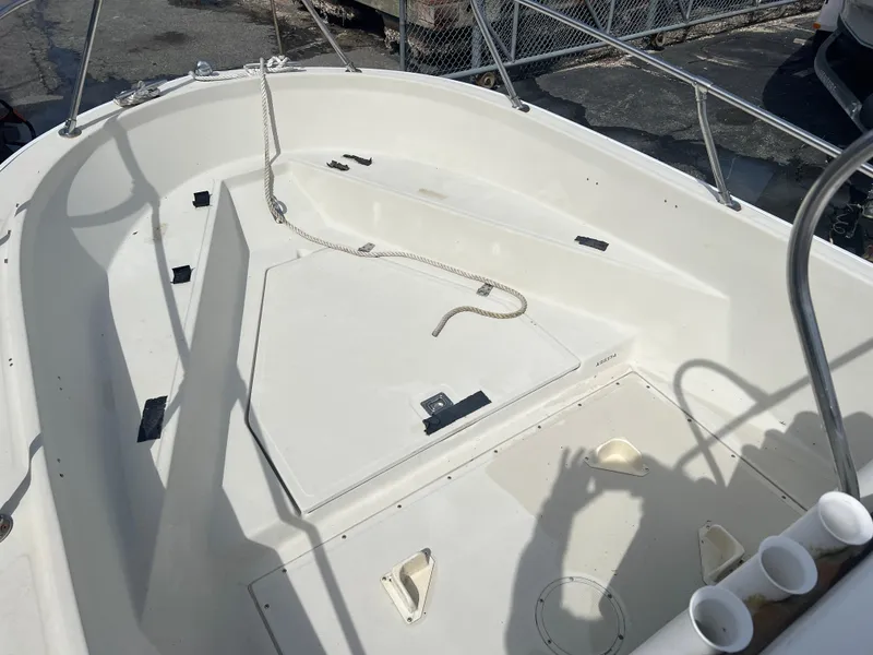 Slide: The Image of 1992 Boston Whaler 19 OUTRAGE boat interior with white deck and storage compartments. - 6