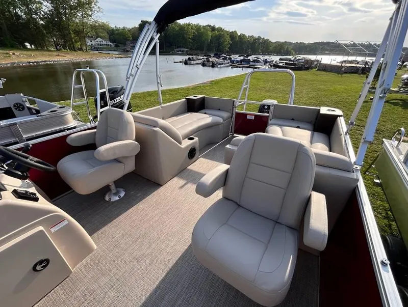 Slide: The Image of 2024 Landau Island Breeze 232 Cruise pontoon boat with spacious seating by a serene lake. - 3