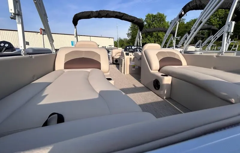 Slide: The Image of 2024 Landau Island Breeze 232 Cruise pontoon boat interior with beige seating and canopy. - 6