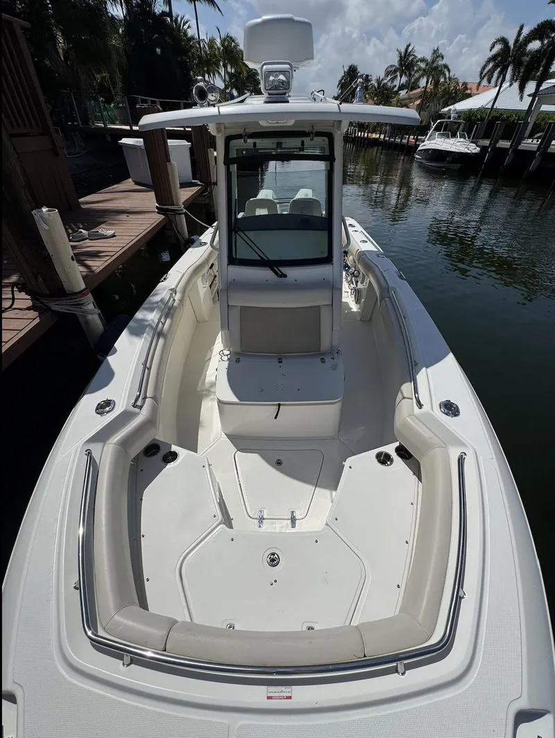 Slide: The Image of 2019 Boston Whaler 250 Outrage boat docked, featuring spacious seating and sleek design. - 4