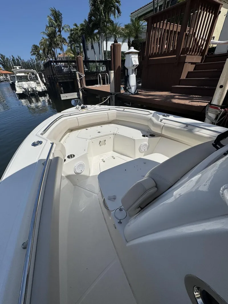 Slide: The Image of 2019 Boston Whaler 250 Outrage boat docked, featuring spacious seating and sleek design. - 6