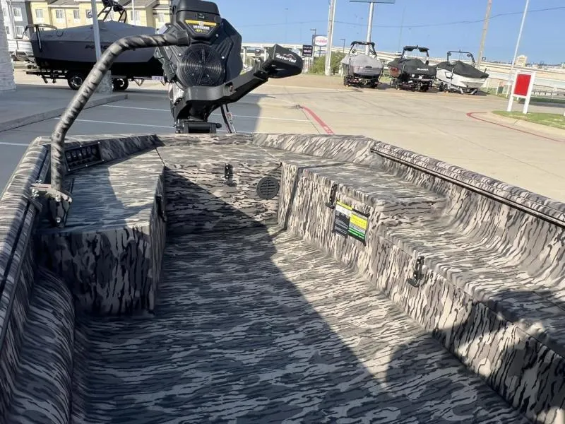 Slide: The Image of 2025 Havoc Boats 1653 MSTC with camouflage interior, parked outdoors. - 11