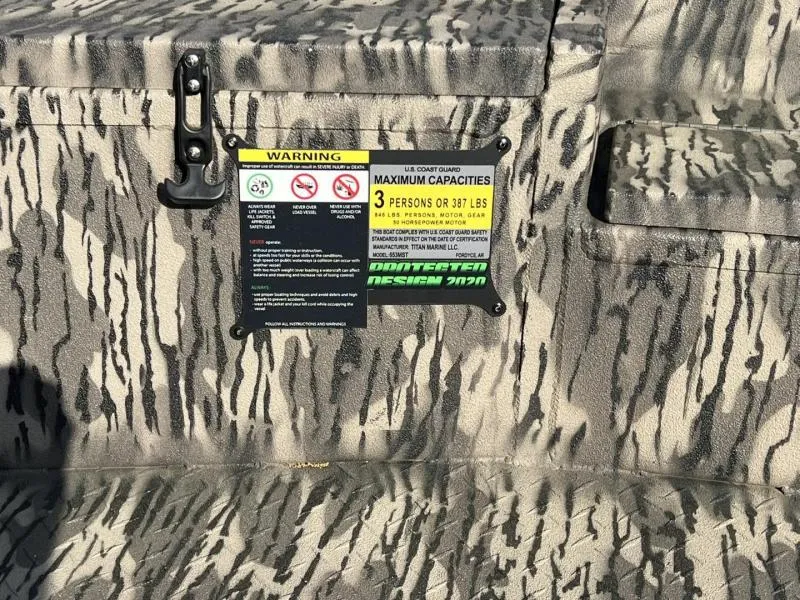 Slide: The Image of Camouflage-patterned Havoc Boats 1653 MSTC 2025 with capacity warning label for 3 persons or 387 lbs. - 12