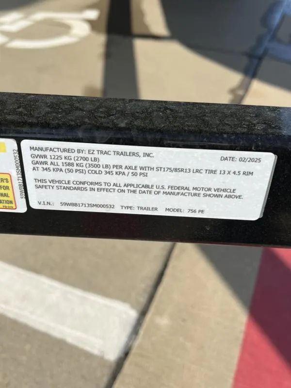 Slide: The Image of Sticker on trailer showing specifications and compliance details, manufactured by EZ Trac Trailers, Inc. - 19