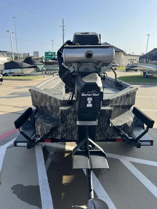 Slide: The Image of 2025 Havoc Boats 1653 MSTC with Gator Tail motor on trailer, outdoor display. - 4