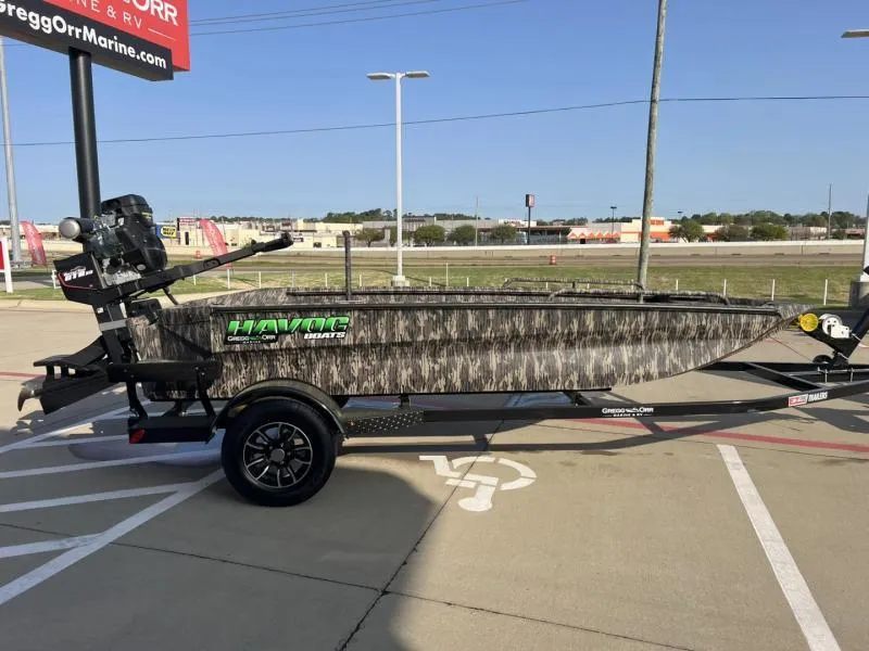 Slide: The Image of 2025 Havoc Boats 1653 MSTC camo-patterned boat on trailer in parking lot. - 6