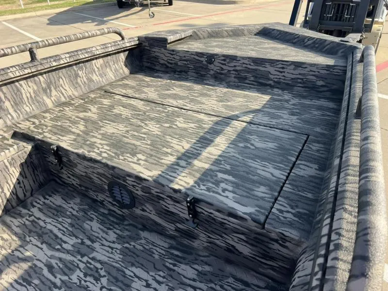 Slide: The Image of 2025 Havoc Boats 1653 MSTC with camouflage interior design, parked outdoors. - 9