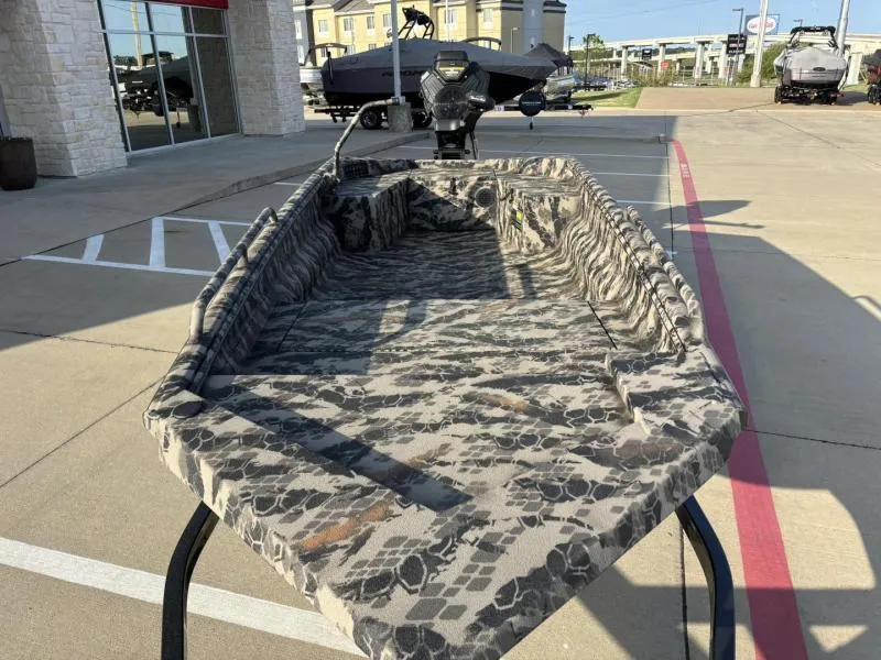 Slide: The Image of 2025 Havoc Boats 1653 MSTC with camouflage design, displayed outdoors on a sunny day. - 12