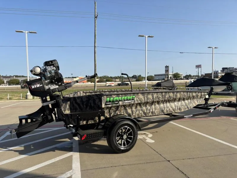 Slide: The Image of 2025 Havoc Boats 1653 MSTC camo-patterned boat on trailer in parking lot. - 3