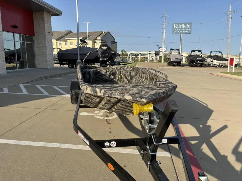 Slide: The Image of 2025 Havoc Boats 1653 MSTC camo boat on trailer in parking lot. - 5