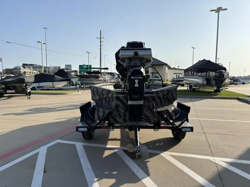 Slide: The Image of 2025 Havoc Boats 1653 MSTC on trailer in parking lot, surrounded by other boats. - 6