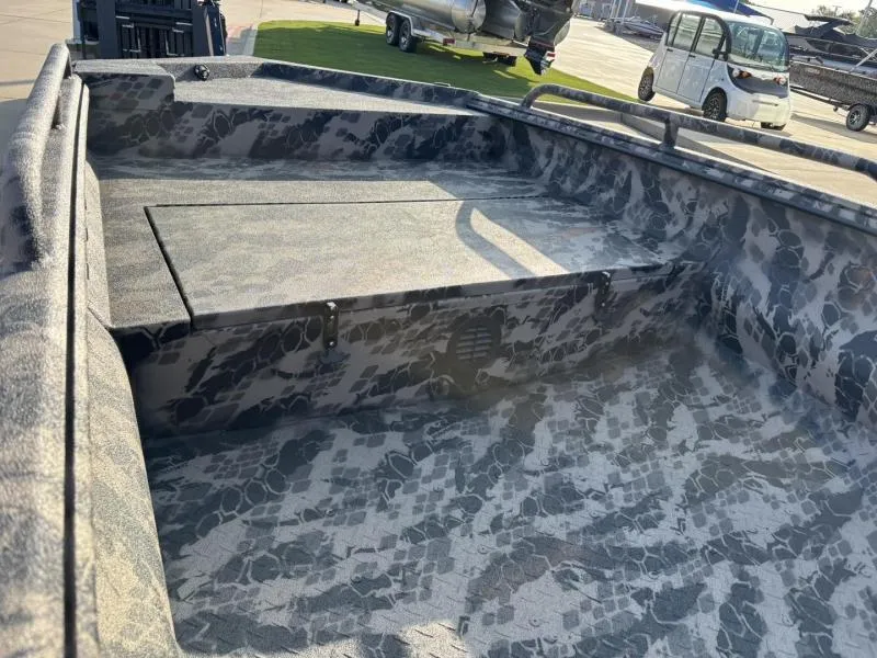 Slide: The Image of 2025 Havoc Boats 1653 MSTC interior with camouflage design, parked outdoors. - 8