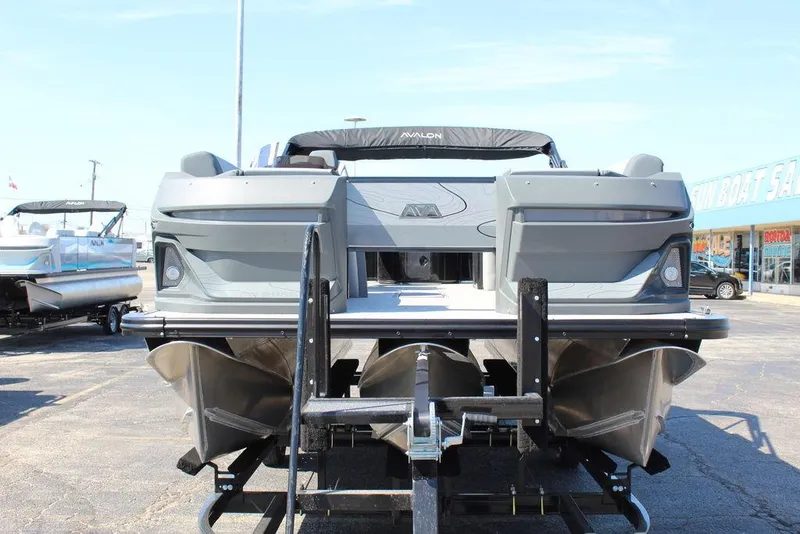 Slide: The Image of 2025 Avalon GEO FISH REAR FISH boat on trailer, rear view in outdoor setting. - 10