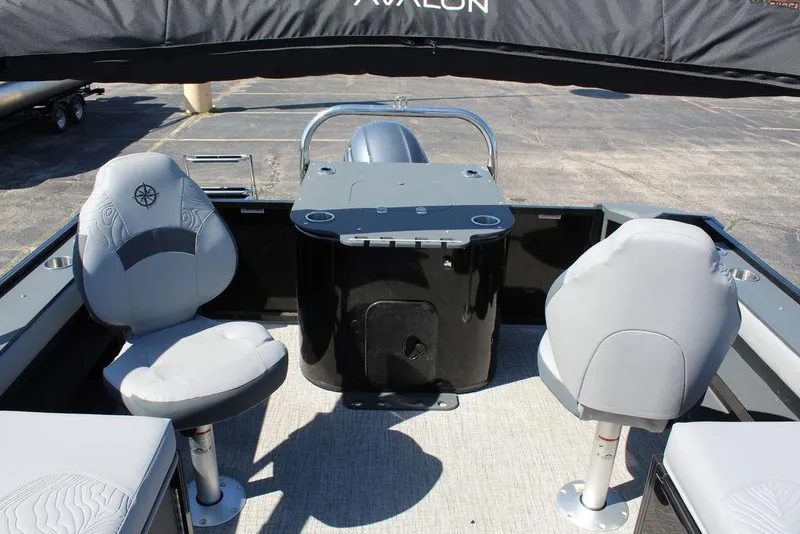 Slide: The Image of 2025 Avalon GEO FISH REAR FISH boat interior with two swivel seats and a control console. - 20