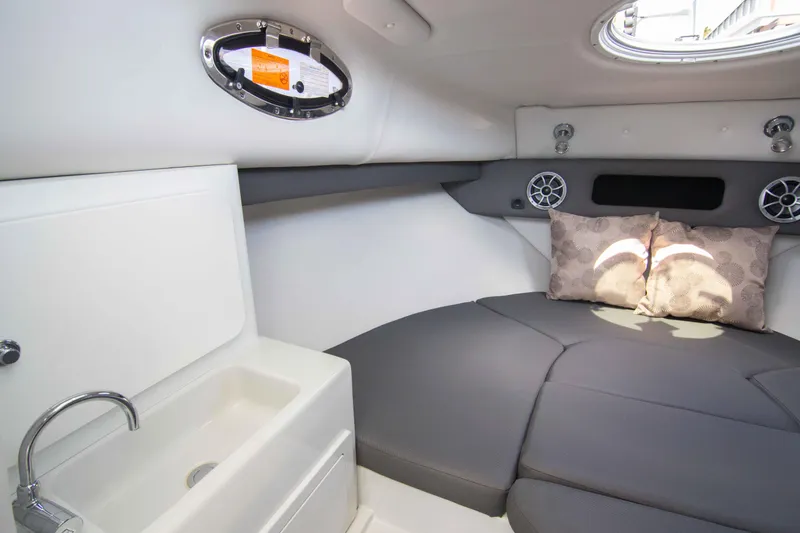 Slide: The Image of 2024 Finseeker 245 WA cabin interior with sink, cushions, and porthole window. - 16