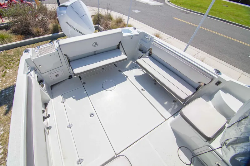 Slide: The Image of 2024 Finseeker 245 WA boat deck with seating and outboard motor. - 4