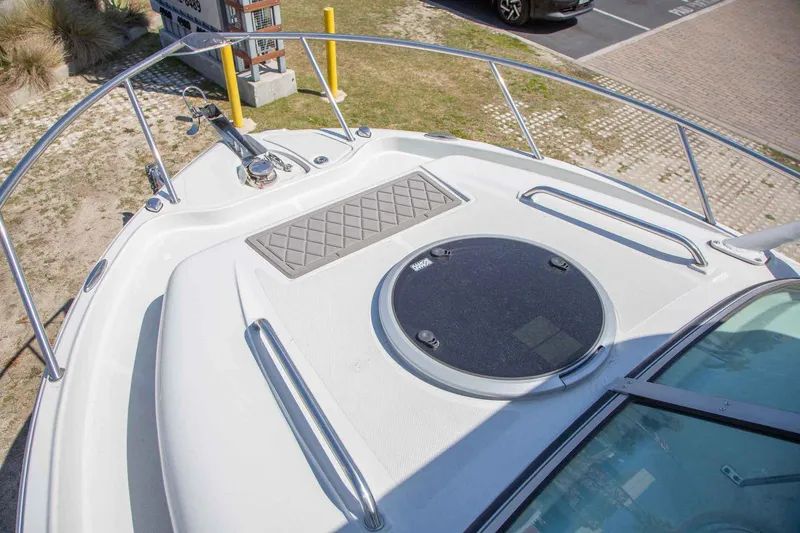 Slide: The Image of 2024 Finseeker 245 WA boat deck with hatch and railing, docked outdoors. - 9