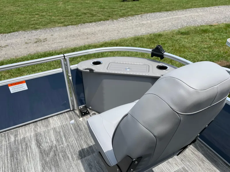 Slide: The Image of 2024 Landau A'Lure 212 Fishing boat seat with cup holders and railing, on grassy background. - 11