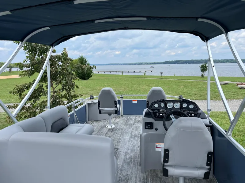 Slide: The Image of 2024 Landau A'Lure 212 Fishing boat interior with lake view, featuring seating and control panel. - 12