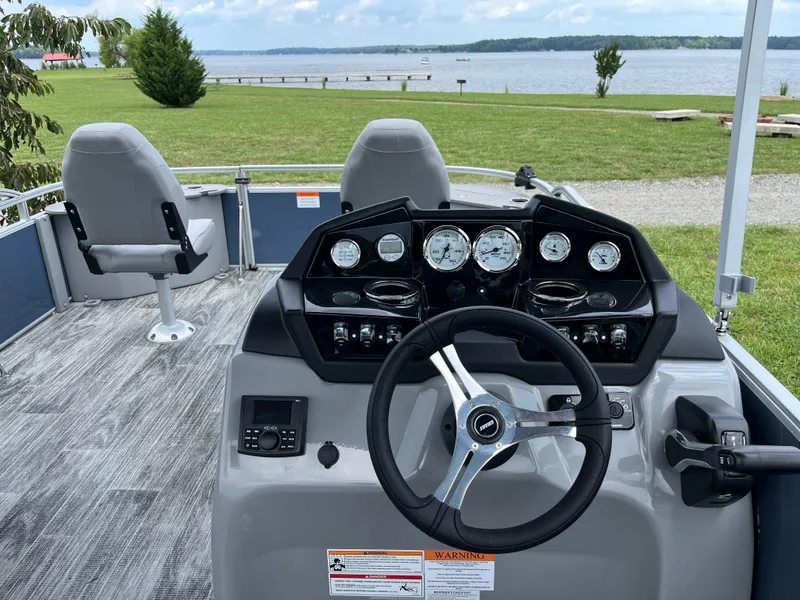 Slide: The Image of 2024 Landau A'Lure 212 Fishing boat interior with steering wheel and lake view. - 15