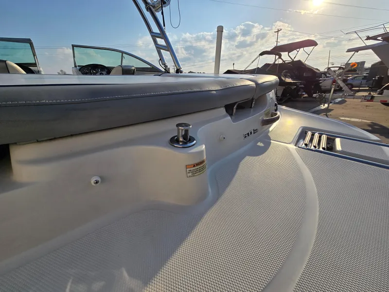 Slide: The Image of 2008 Sea Ray 205 Sport boat deck with seating and cleat under sunny sky. - 11