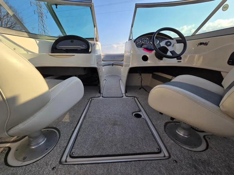 Slide: The Image of Interior view of a 2008 Sea Ray 205 Sport boat, featuring dual seats and steering console. - 14