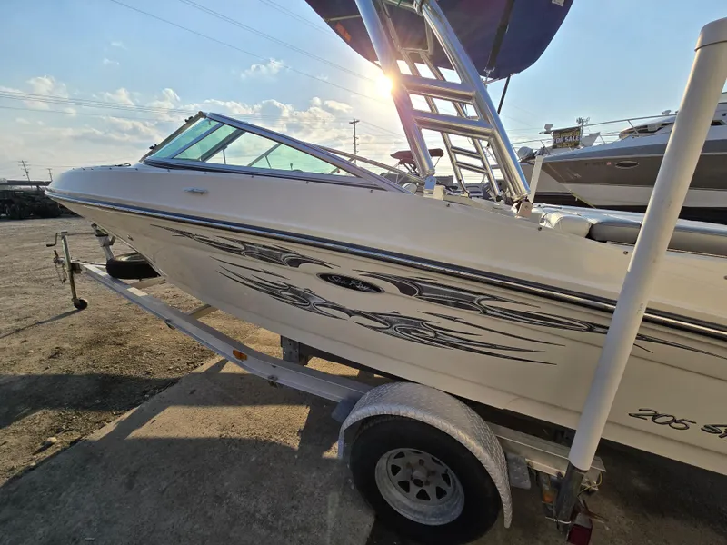 Slide: The Image of 2008 Sea Ray 205 Sport boat on trailer, sunlit, with stylish graphics. - 3