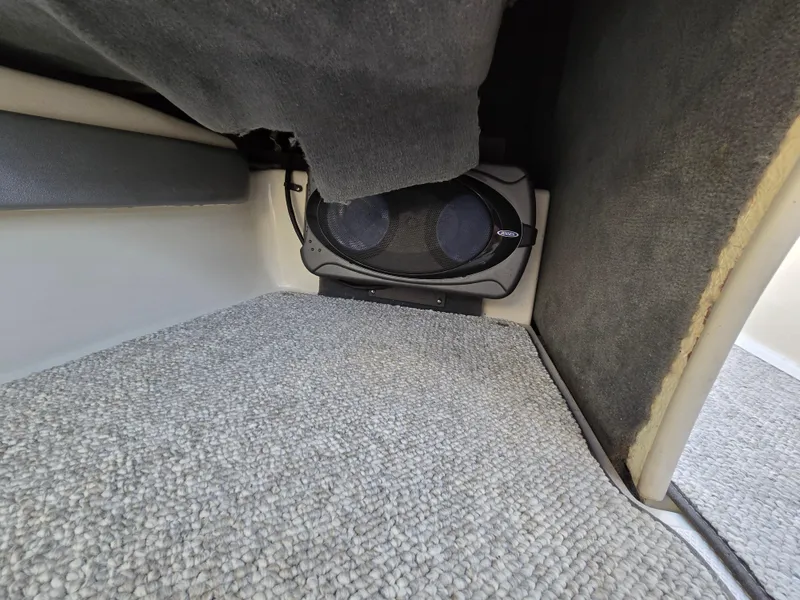 Slide: The Image of Interior view of a 2008 Sea Ray 205 Sport boat with carpeted flooring and speaker system. - 34